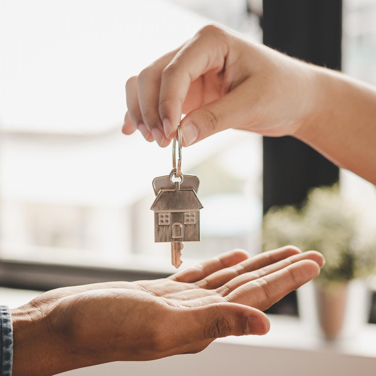 a person being handed keys to their new home